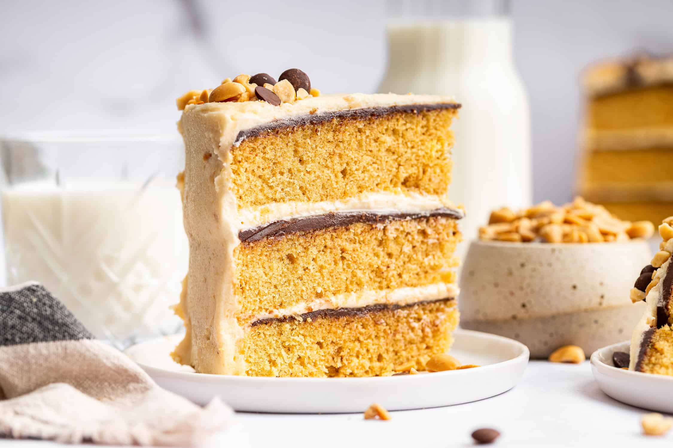 A 9x13 pan of peanut butter cake baking on an oven rack with the cake risen and lightly golden on top