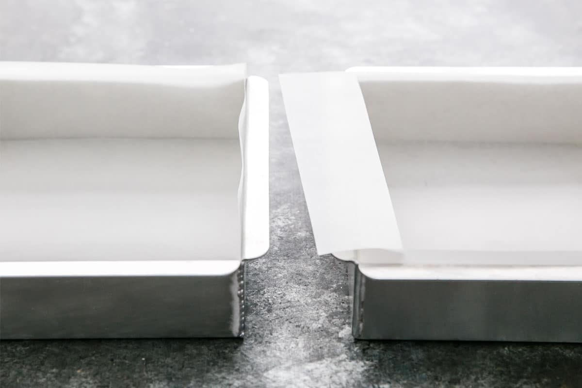 A baking sheet lined with parchment paper on a kitchen counter, ready for fortune cookie batter