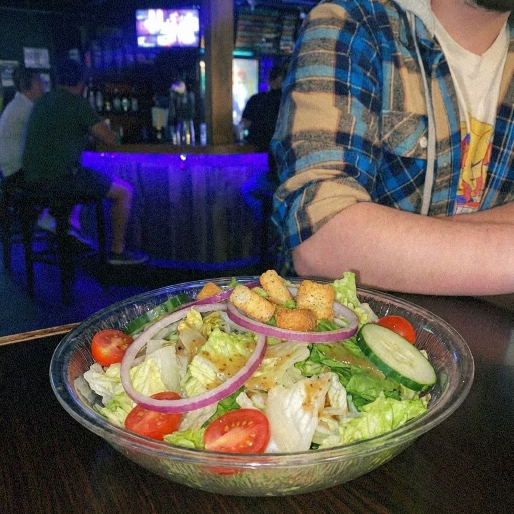 A bowl of crisp garden salad with cucumbers and tomatoes