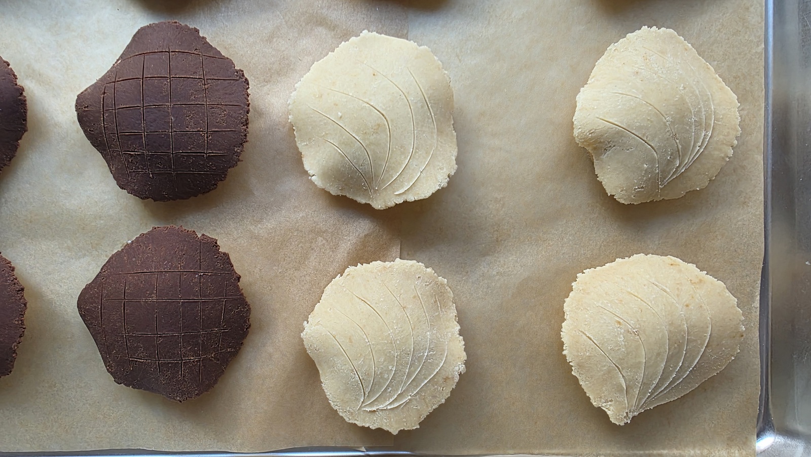 A bowl of pale sugar topping dough for conchas with a spatula resting inside on a kitchen counter