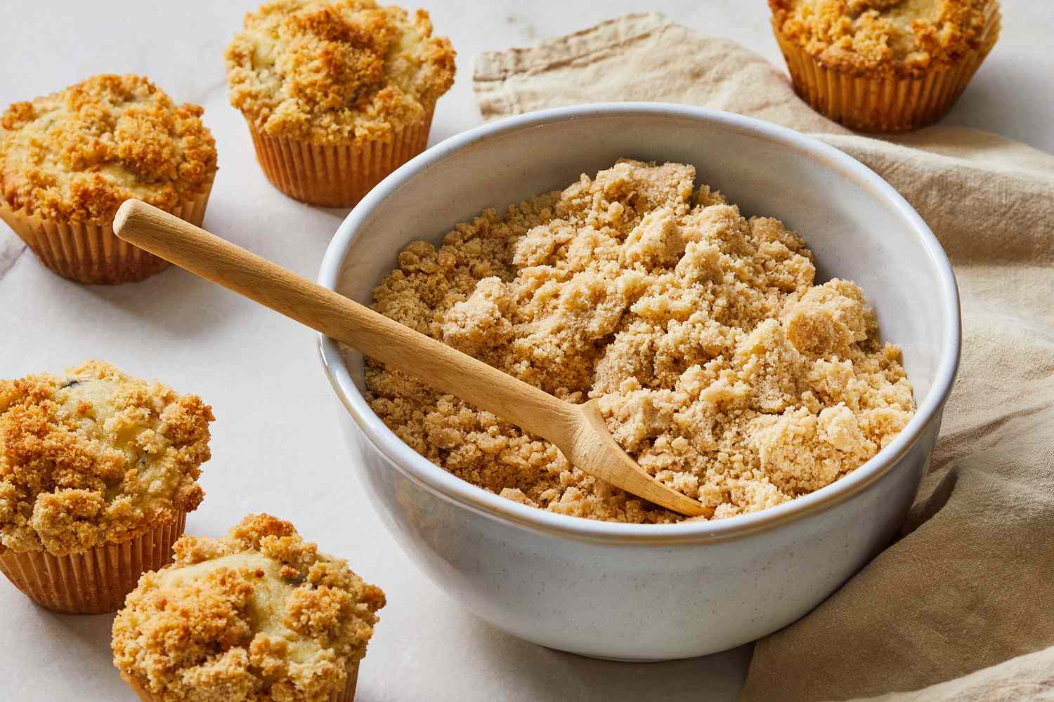 A close-up of buttery oat crumble topping with visible clumps and toasted golden edges