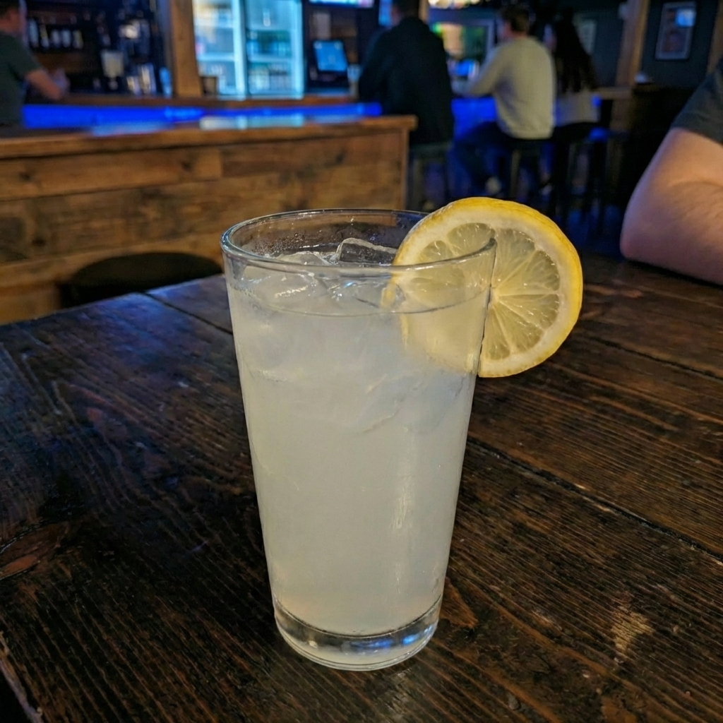 A glass of homemade lemonade with ice and a lemon slice