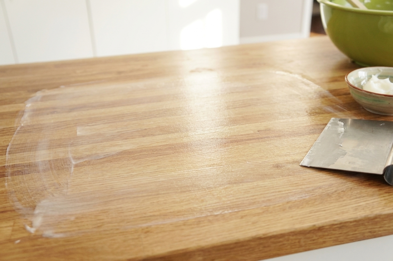 A home kitchen counter lightly greased with shortening, ready for kneading fondant
