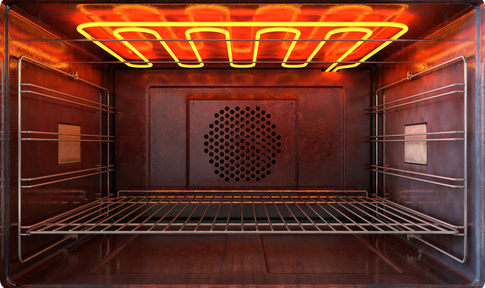 A home oven preheating with a clean rimmed baking sheet heating inside, warm kitchen lighting