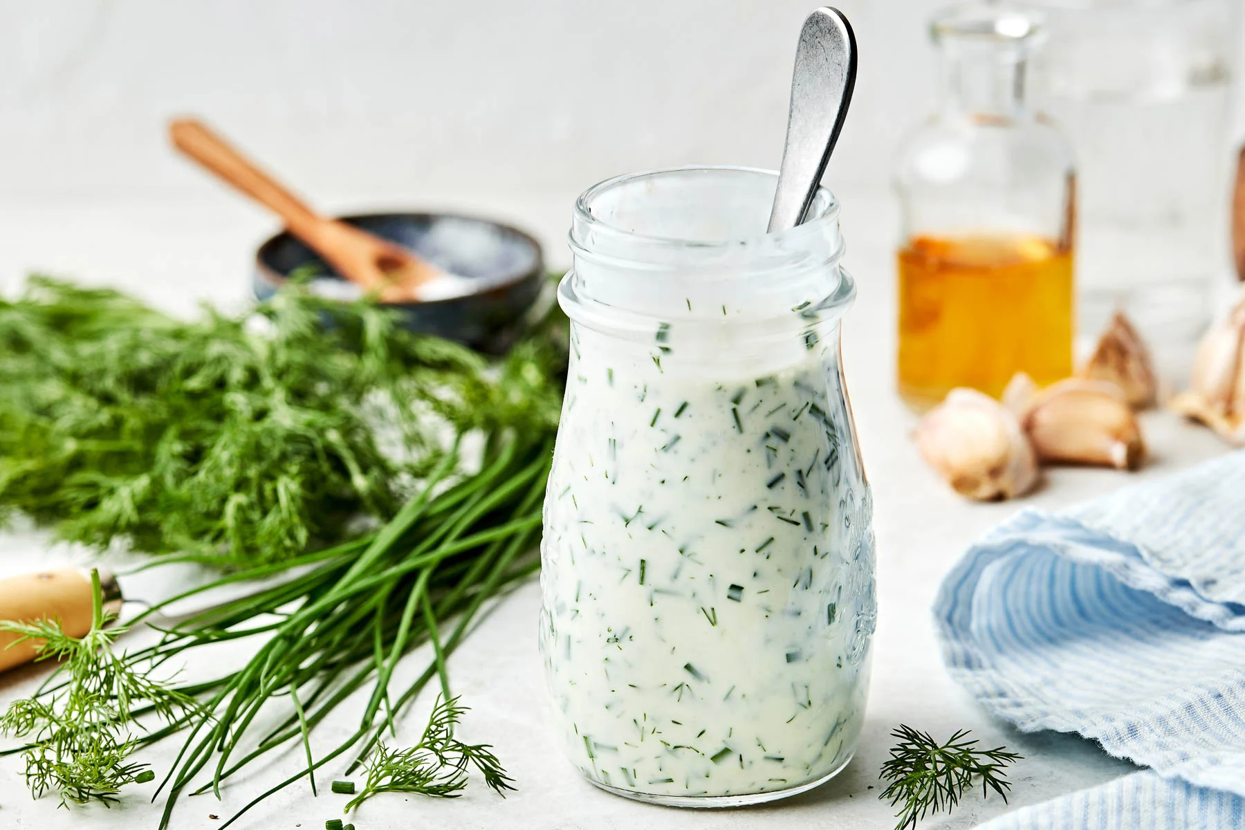 A mason jar filled with creamy ranch dressing with a lid on, ready to store in the refrigerator.