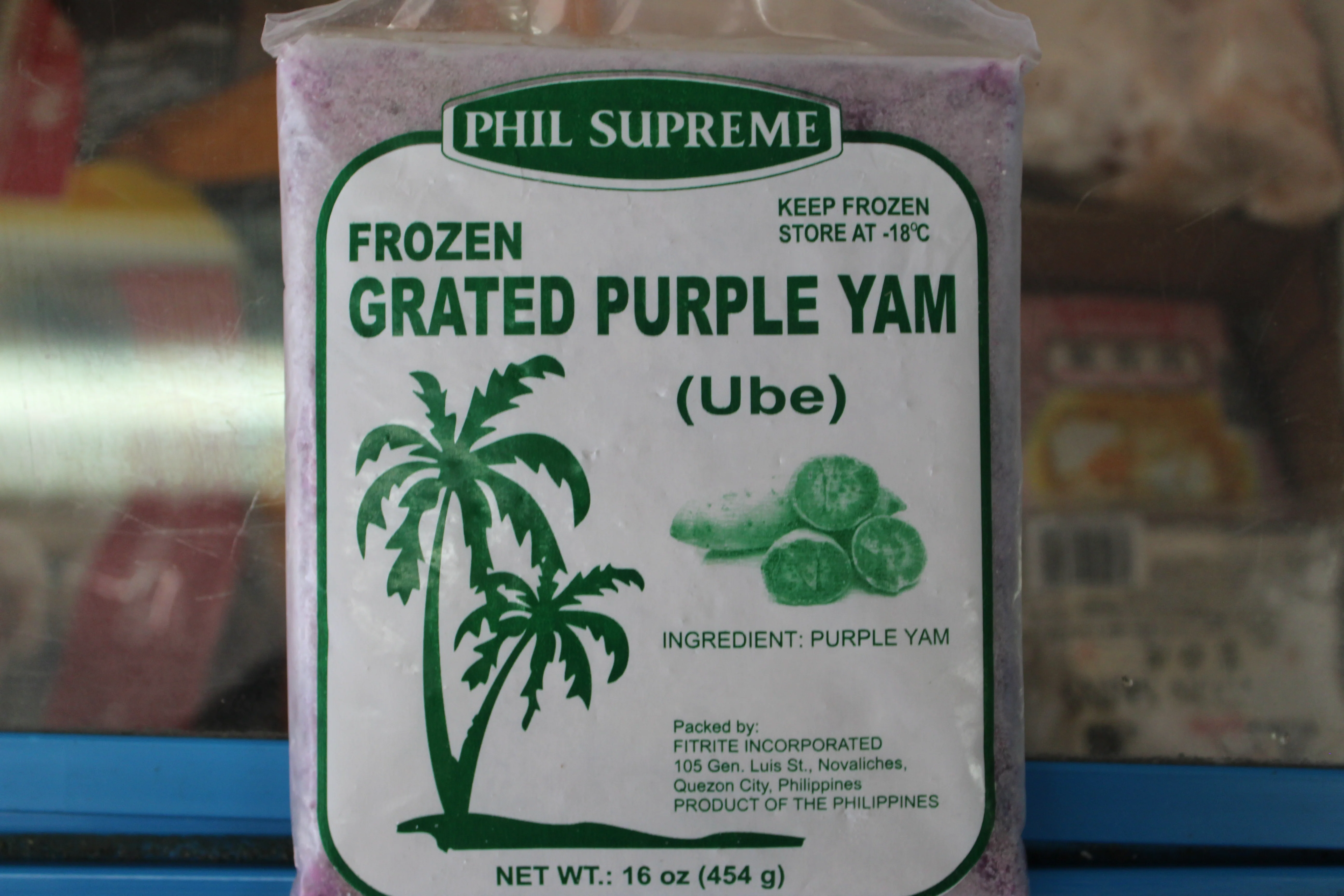 A package of frozen grated ube (purple yam) on a kitchen counter next to a bowl and measuring cups, ready for cooking