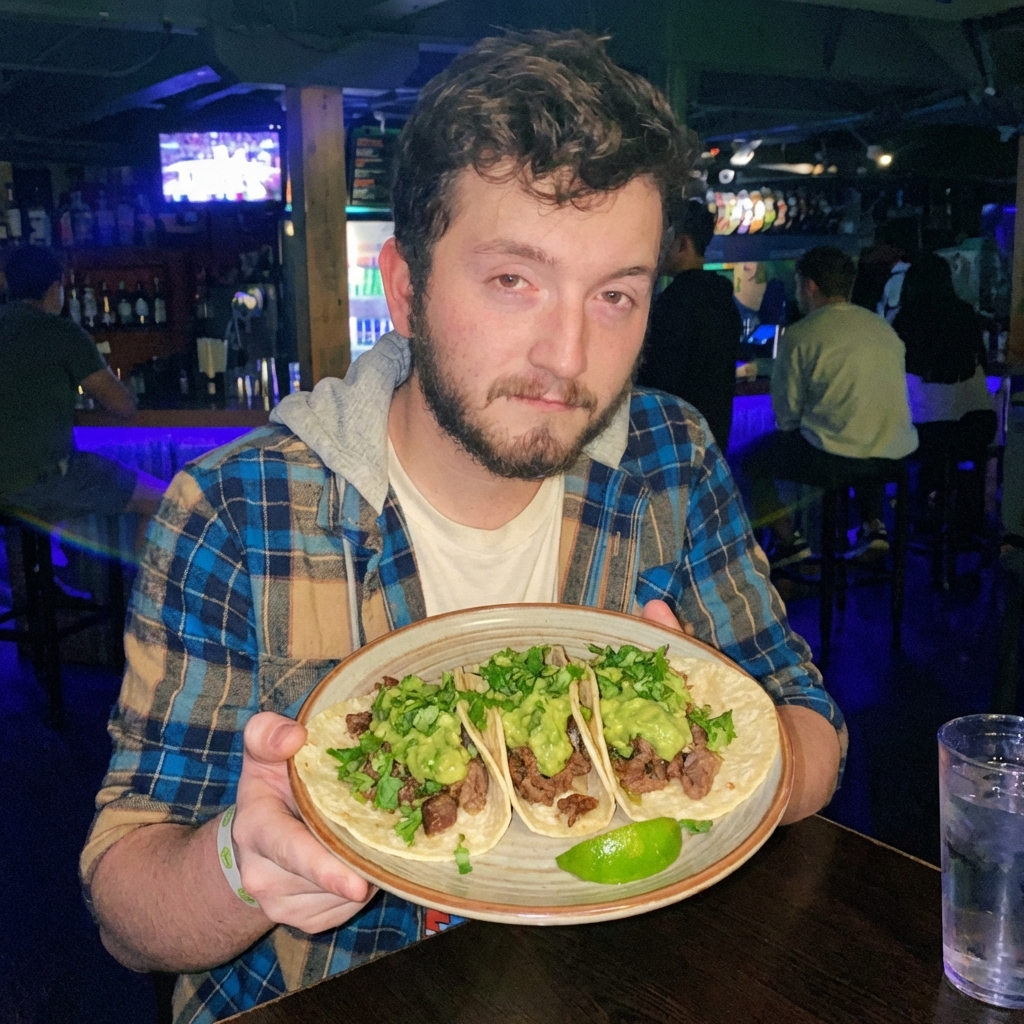 A plate of beef tacos topped with guacamole and cilantro