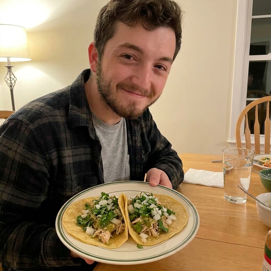 A plate of shredded salsa verde chicken in warm tortillas topped with chopped cilantro and diced onion, casual home dinner photo