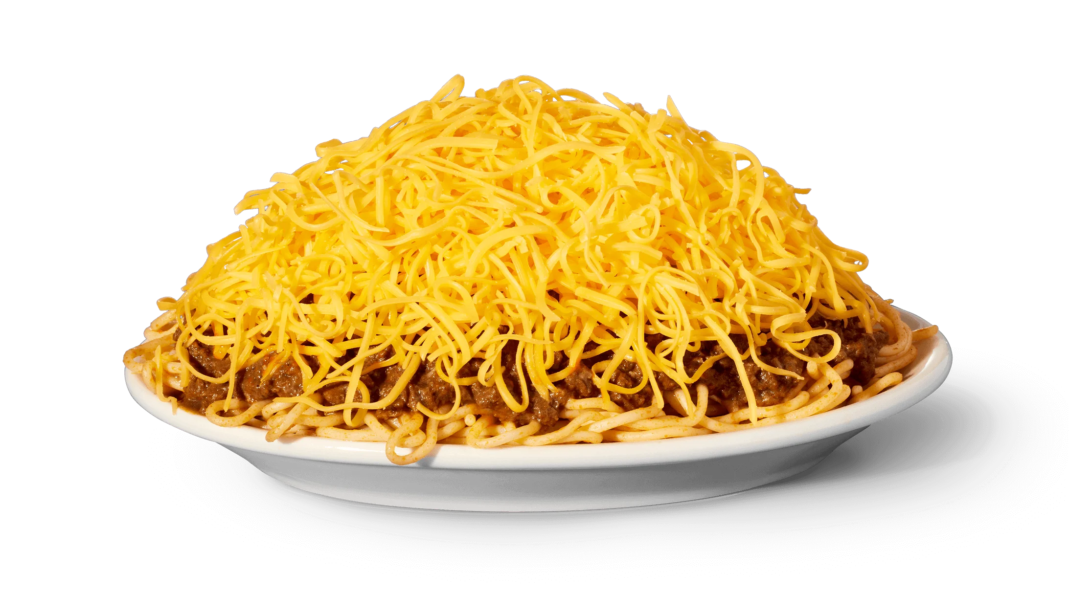 A plated Cincinnati-style Skyline chili 3-way with spaghetti, smooth chili sauce, and a tall mound of finely shredded cheddar on a white plate on a kitchen table