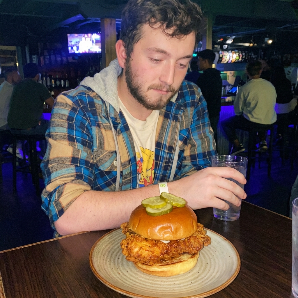 A real photo of a crispy fried chicken sandwich on a bun with pickles