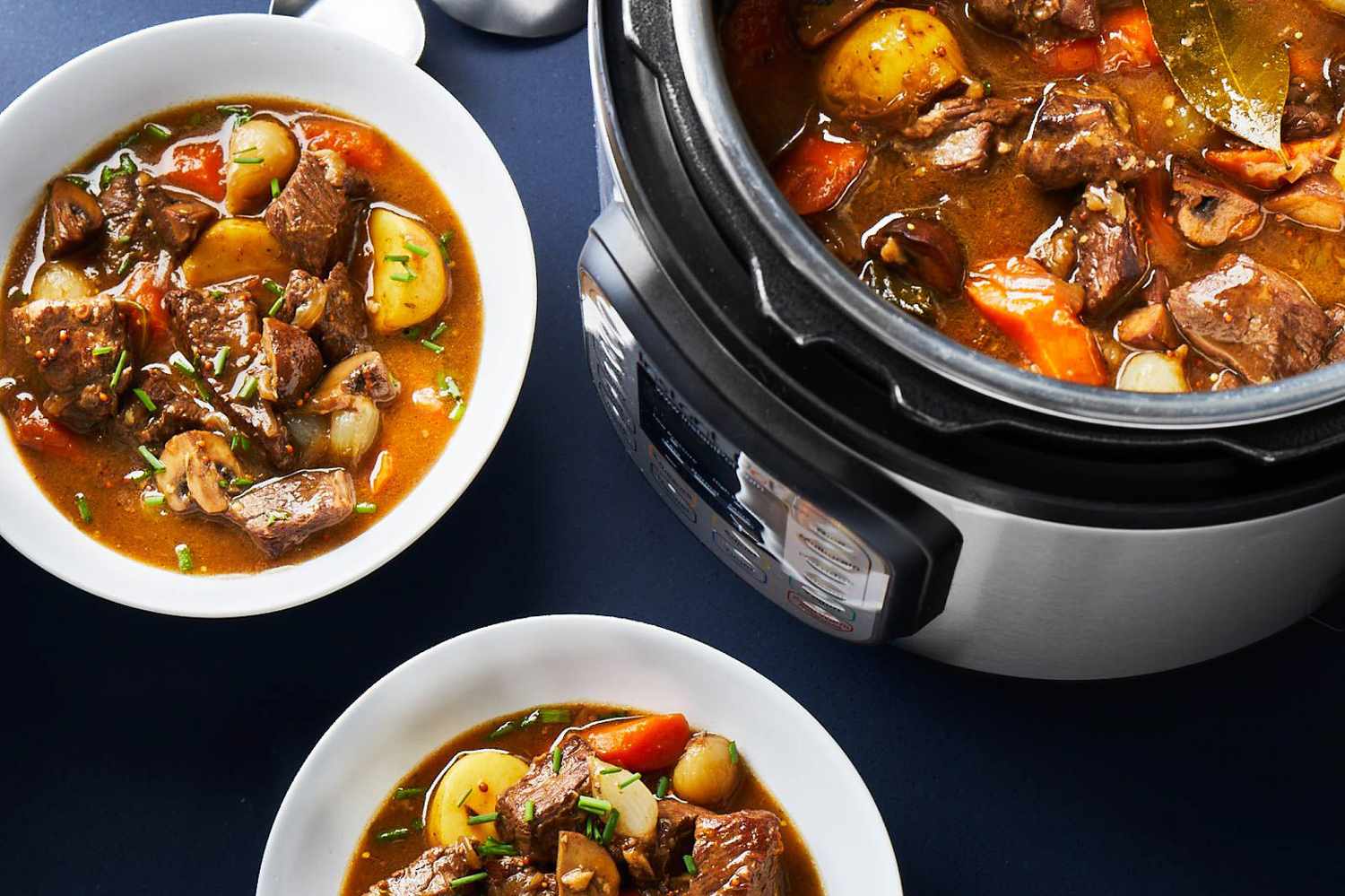 A rustic bowl of Instant Pot beef stew with tender beef chunks, carrots, potatoes, and glossy gravy on a wooden table with a spoon and napkin