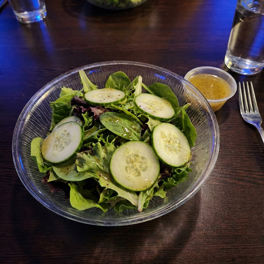 A simple green salad with cucumbers and a light vinaigrette