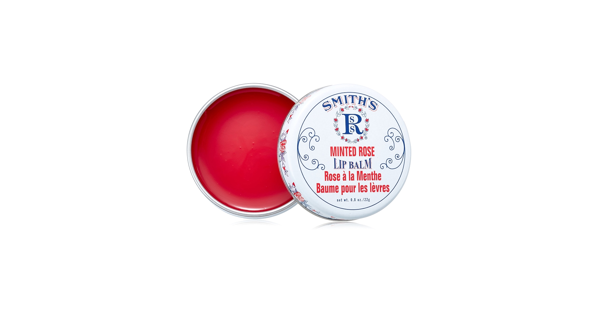 A small metal tin of glow lip balm with a subtle shimmery surface on a light kitchen counter near a wooden spoon