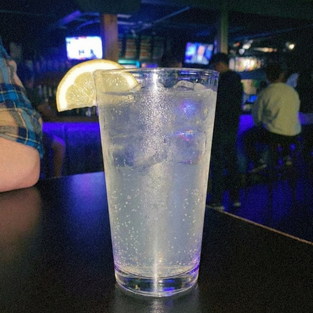 A sparkling lemonade in a glass with a lemon slice