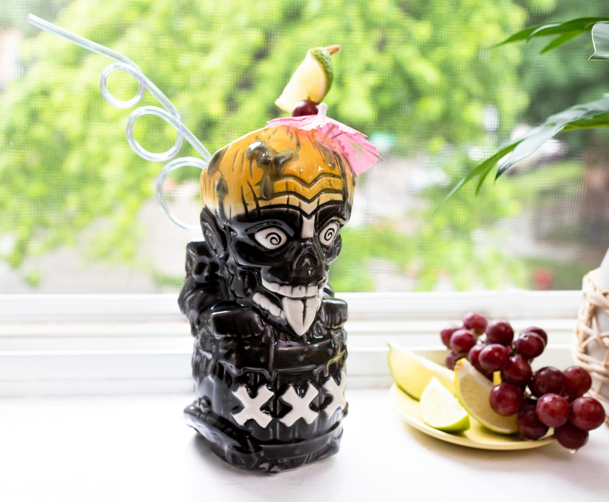 A tiki-style Zombie cocktail in a tall glass packed with crushed ice, garnished with a mint bouquet and citrus slices on a warm-toned kitchen counter