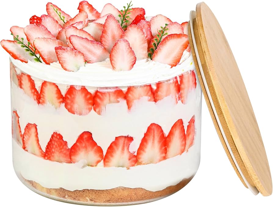 A trifle dish of banana pudding tightly covered with plastic wrap, ready to be chilled.