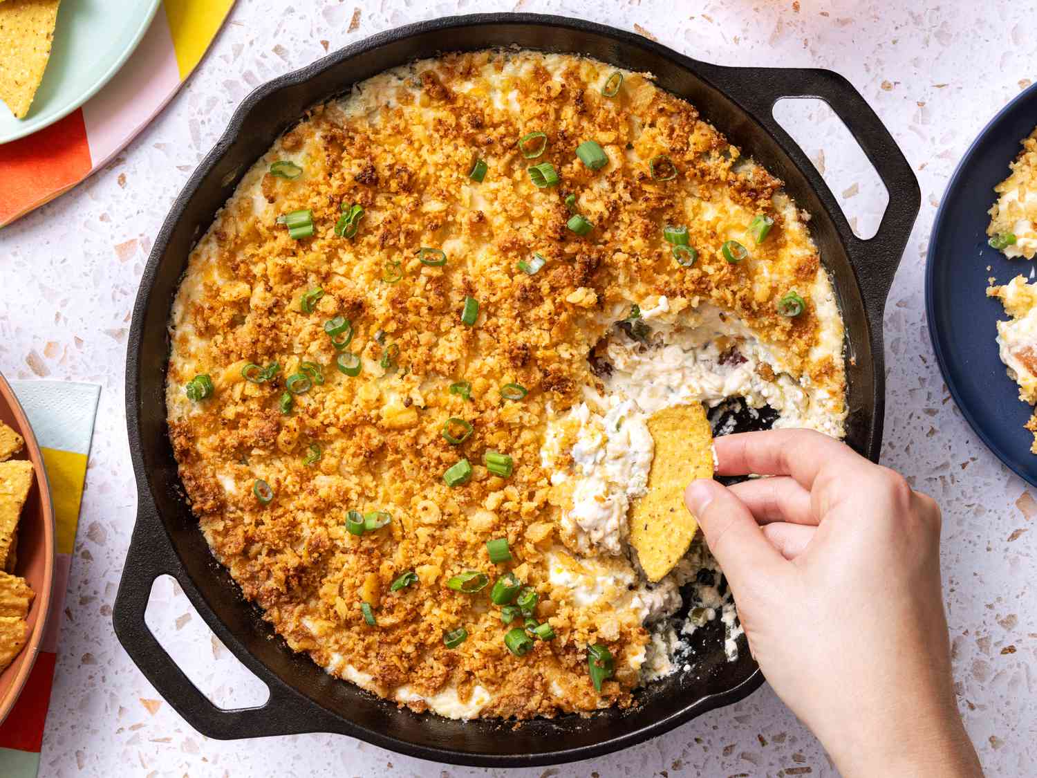 All ingredients for jalapeño popper dip arranged on a clean kitchen counter including cream cheese, sour cream, cheddar, bacon, jalapeños, garlic, green onions, panko, and butter