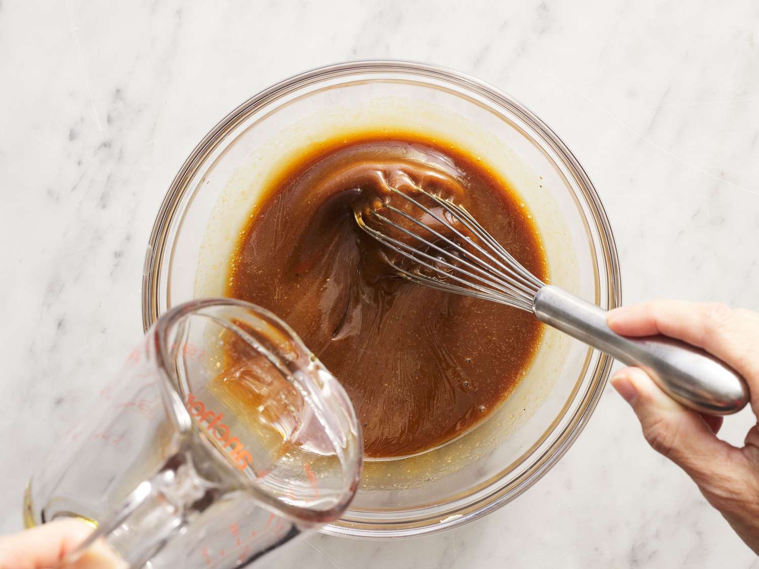 Balsamic vinegar, Dijon mustard, honey, and minced garlic measured out in small bowls on a kitchen counter