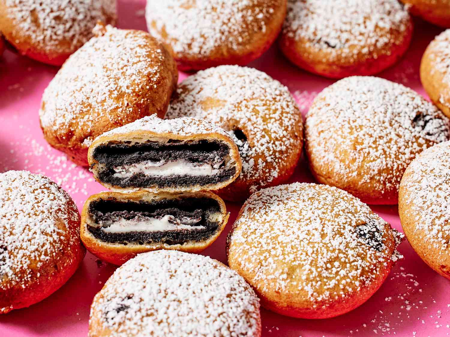 Battered Oreos frying in bubbling oil in a heavy saucepan on a home stove
