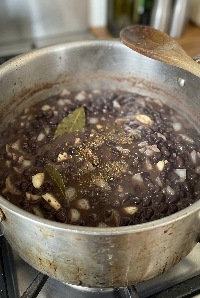 Black beans simmered in a pot with onions and spices