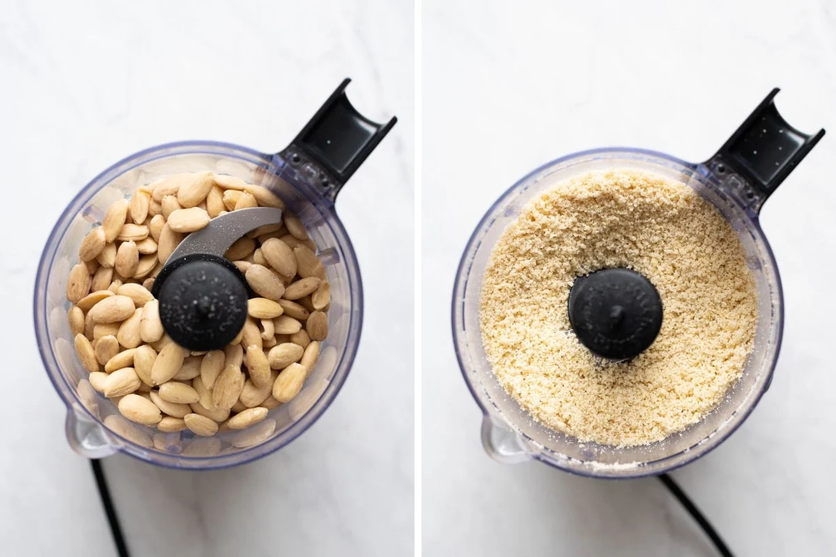 Blanched almonds in the bowl of a food processor on a kitchen counter before blending