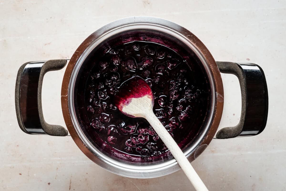 Blueberries, sugar, and lemon juice in a medium saucepan before heating, on a stovetop