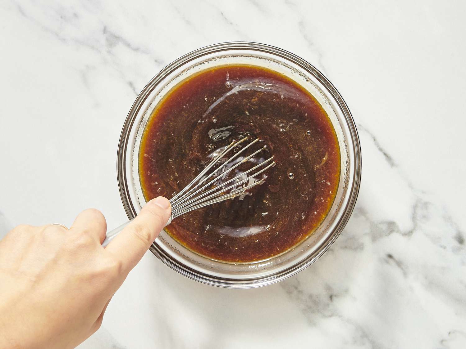 Brown sugar, Dijon mustard, honey, apple cider vinegar, butter, and spices measured on a bright kitchen counter next to a smoked ham