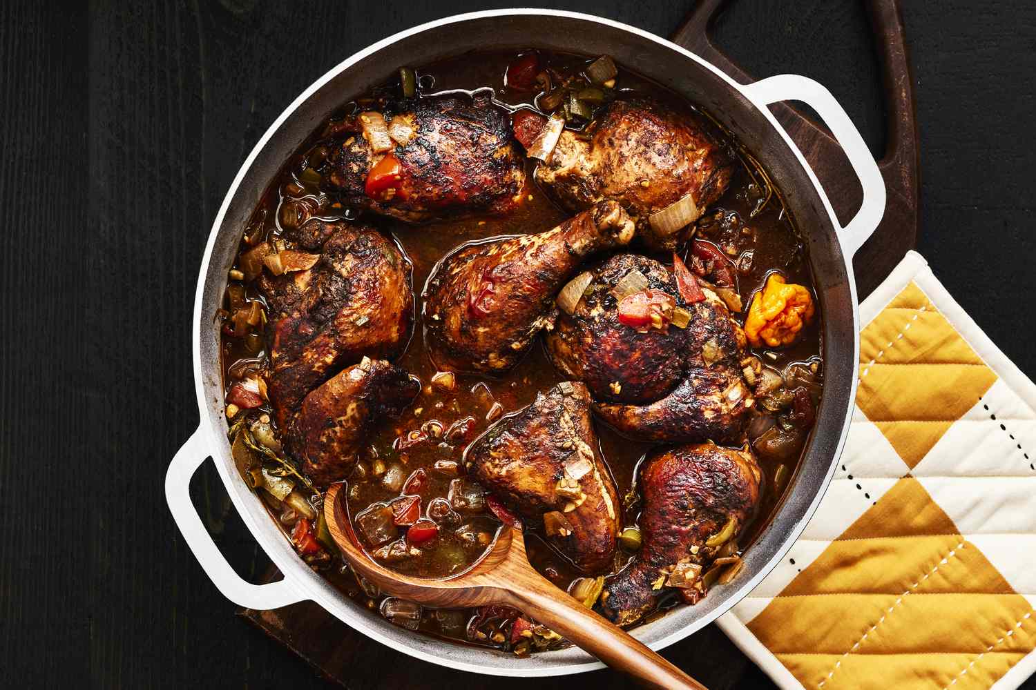 Chicken pieces browning skin-side down in a Dutch oven on a stovetop with golden crisp edges forming