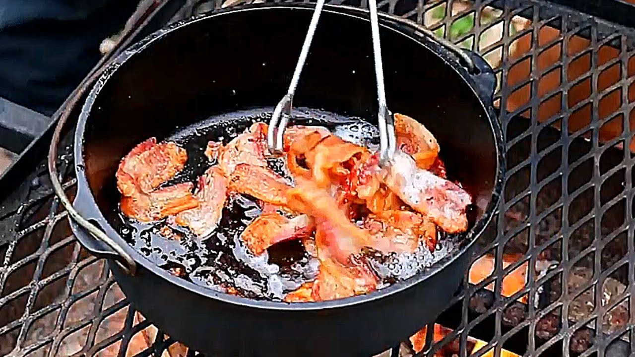 Chopped bacon sizzling and turning golden in a heavy Dutch oven on a stovetop