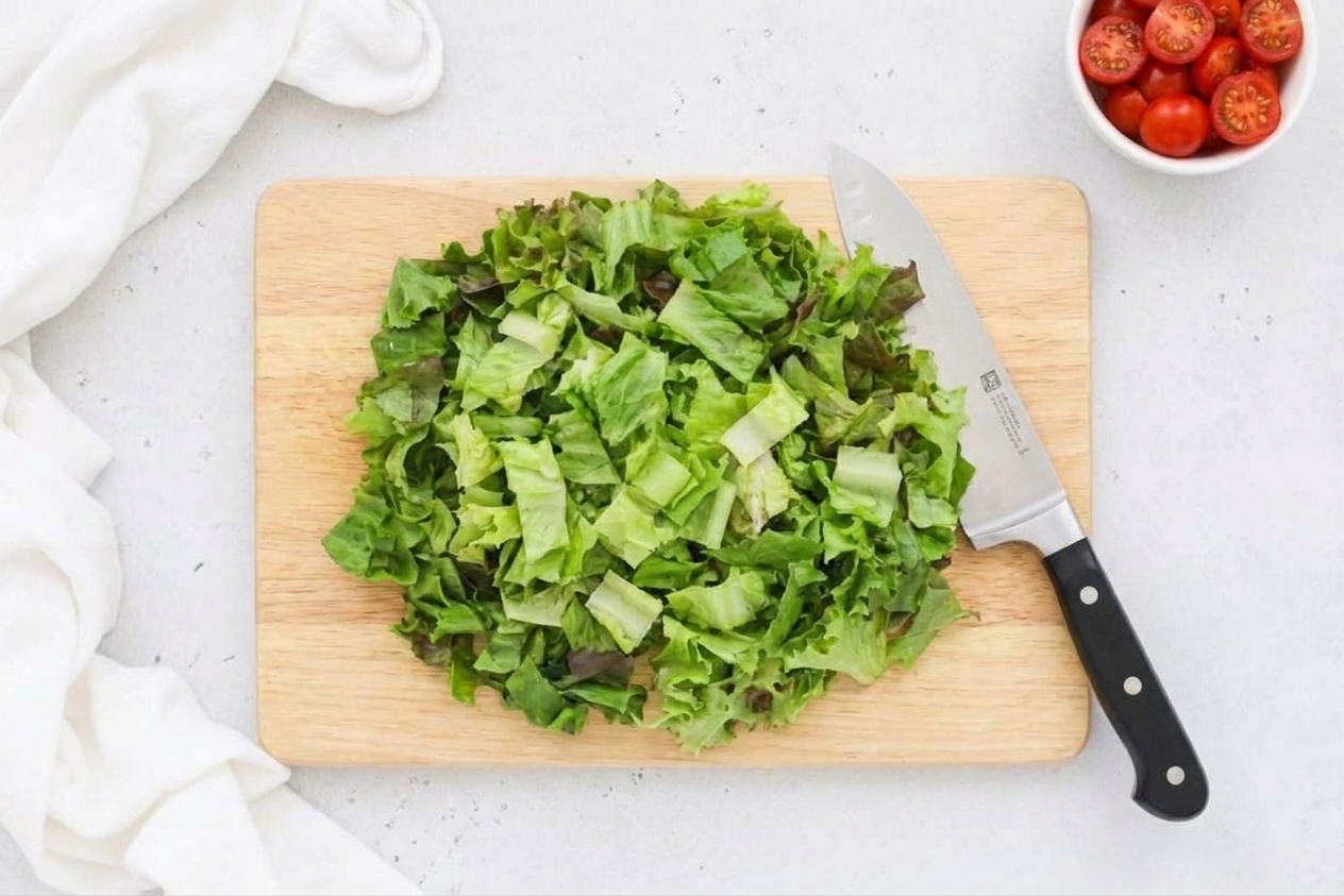Chopped romaine lettuce on a cutting board, ready for a salad