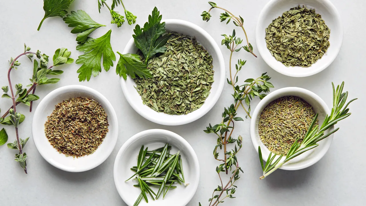 Dried thyme, rosemary, and oregano in small pinch bowls on a bright kitchen counter, ready to be mixed