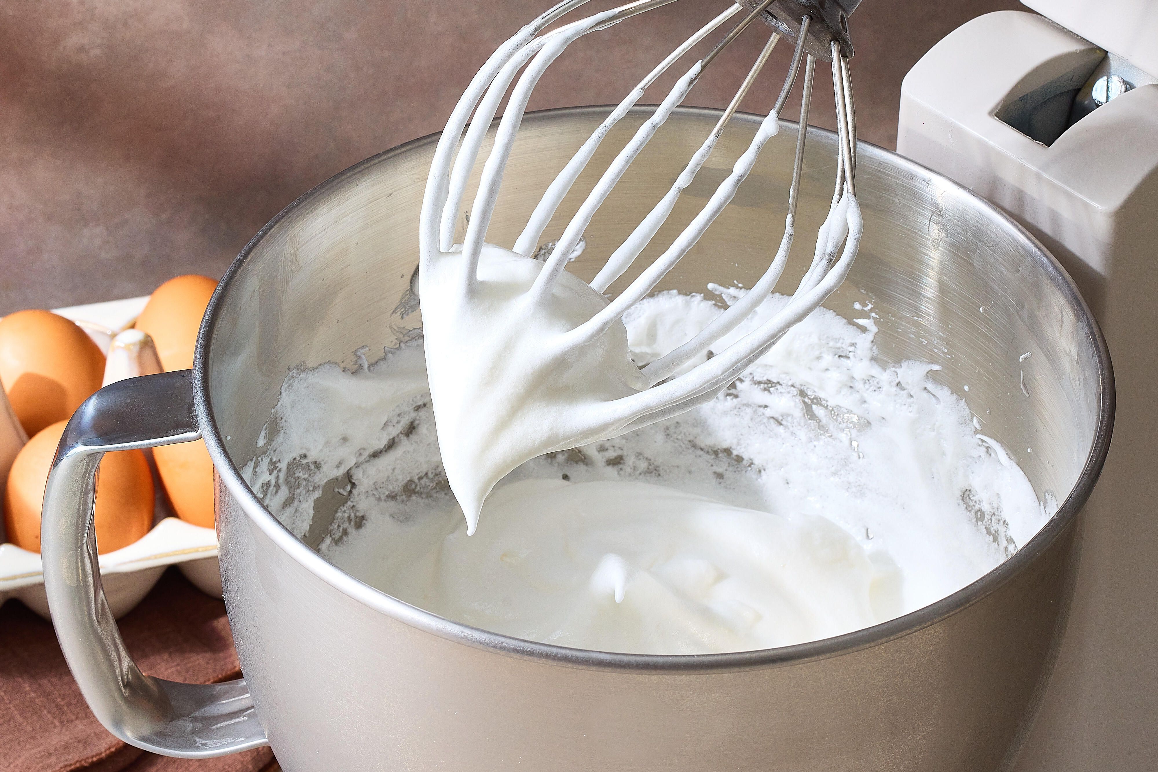 Egg whites in a stainless steel stand mixer bowl ready to be whipped on a bright kitchen counter