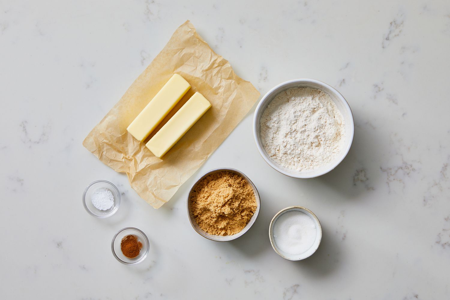 Flour, sugars, cinnamon, oats, and cold butter measured and ready for making crumb topping on a kitchen counter