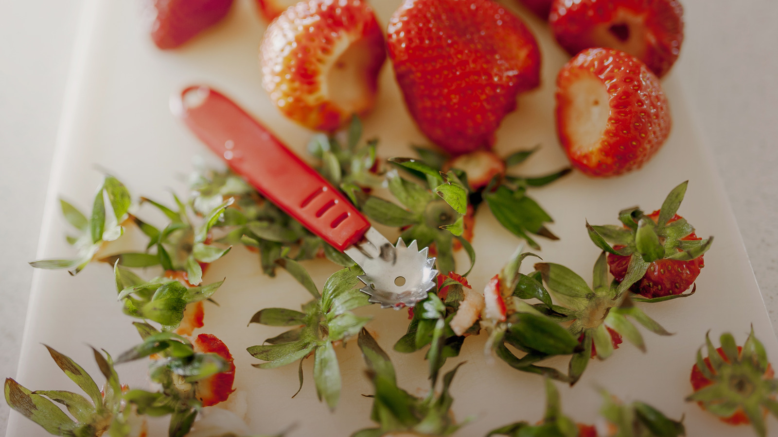 Fresh strawberries with green tops removed, ready to use