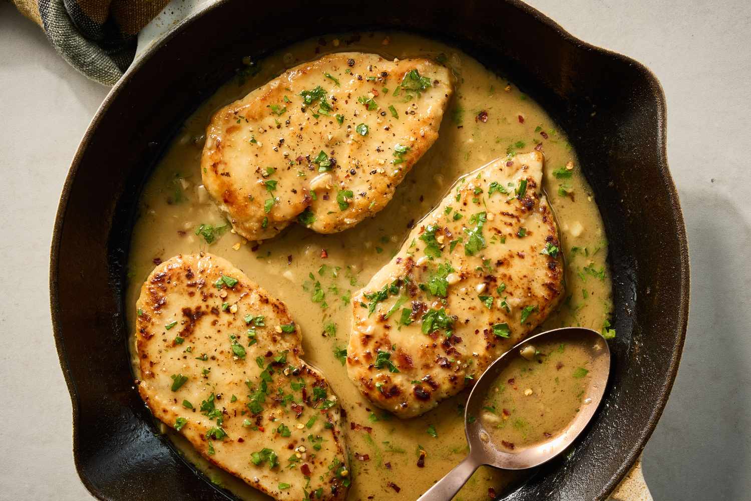Golden-brown chicken cutlets searing in a skillet with lightly crisp edges