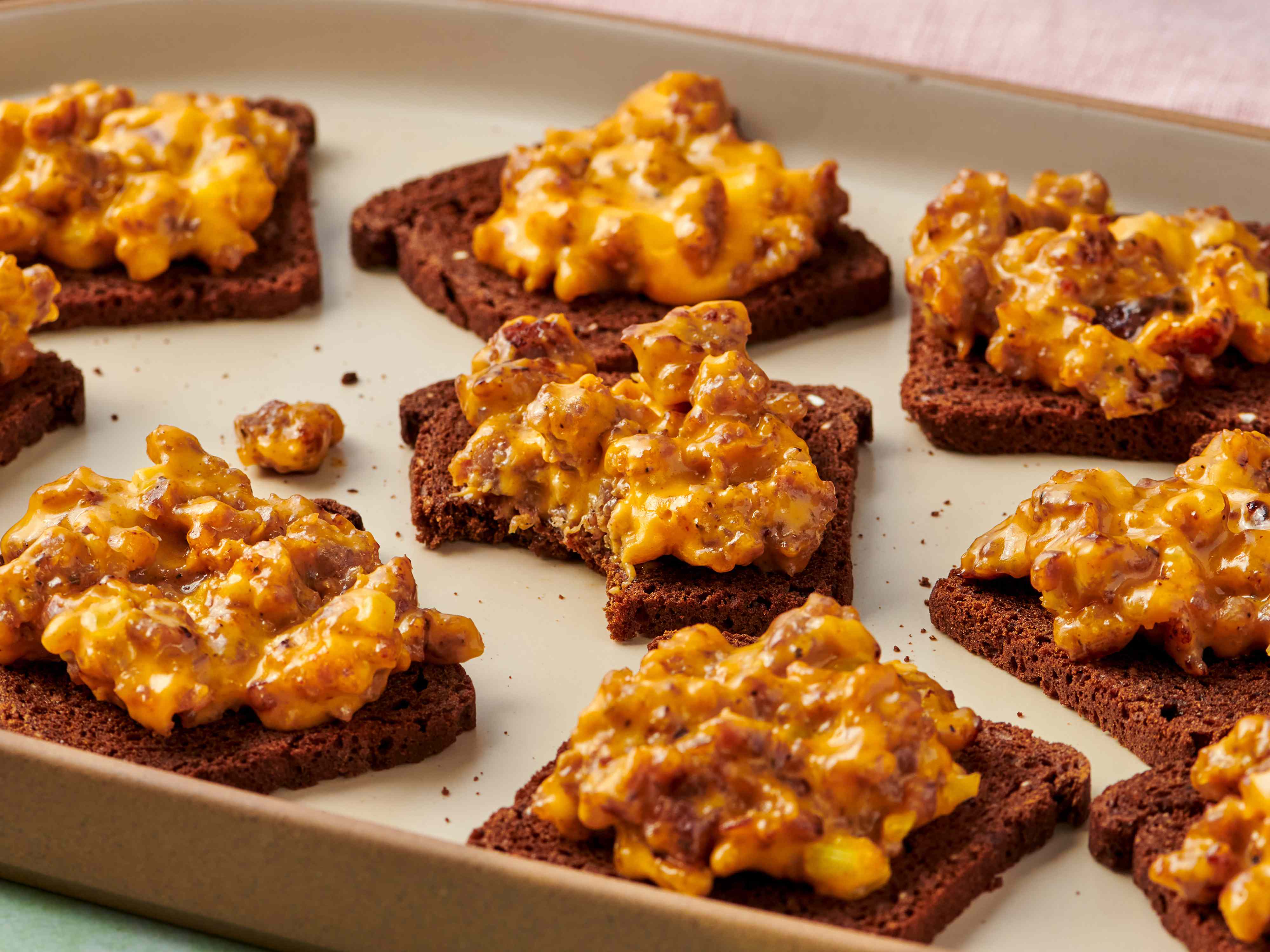 Ground sausage, cubed Velveeta, Worcestershire sauce, garlic powder, and pepper arranged on a kitchen counter