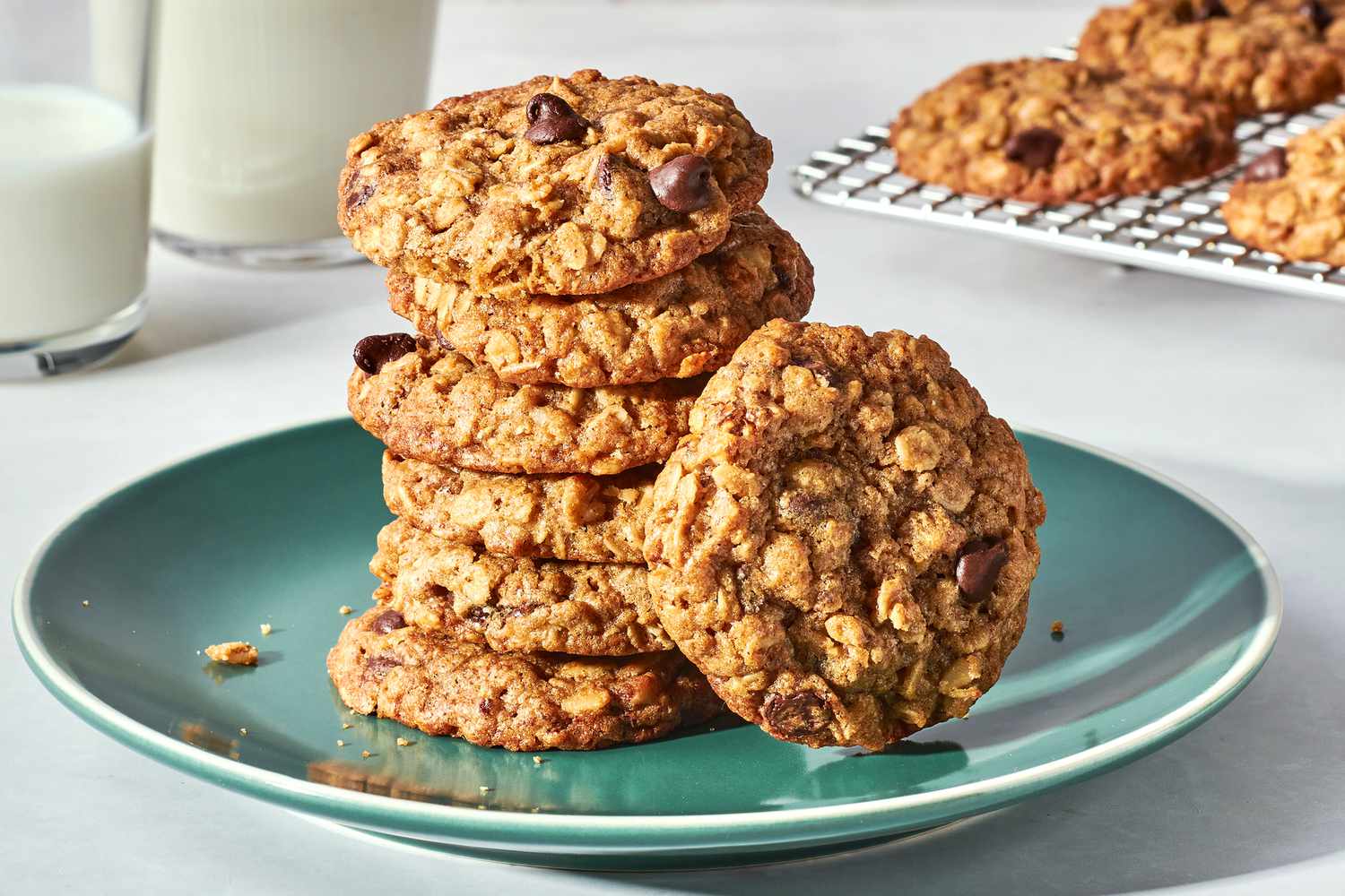 Measured ingredients for lactation cookies including rolled oats, ground flaxseed, brewer’s yeast, flour, brown sugar, butter, eggs, vanilla, and chocolate chips on a kitchen counter