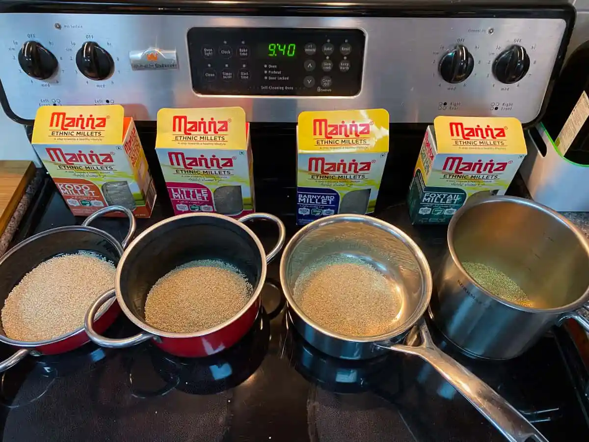 Millet grains toasting in a dry saucepan on a stovetop with a wooden spoon stirring