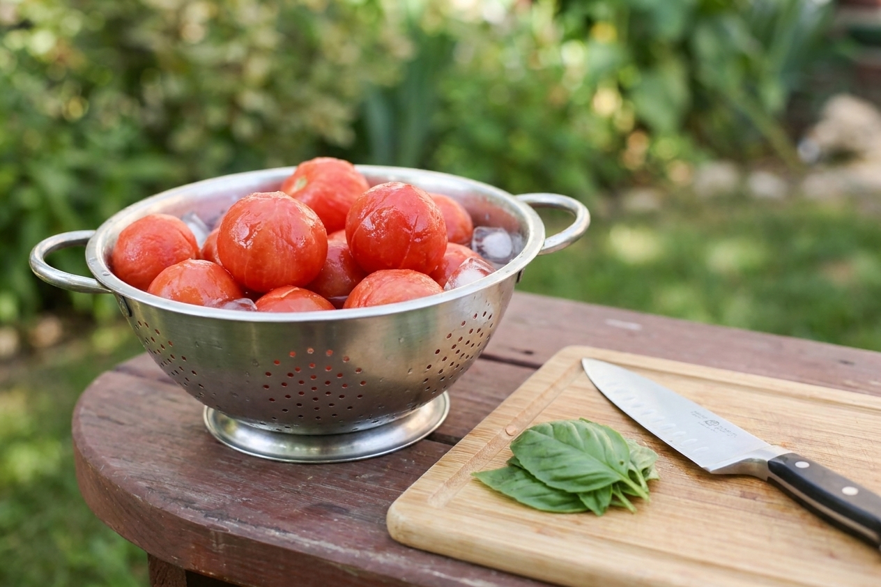 Peeled tomatoes after blanching and cooling in an ice bath, ready to be chopped