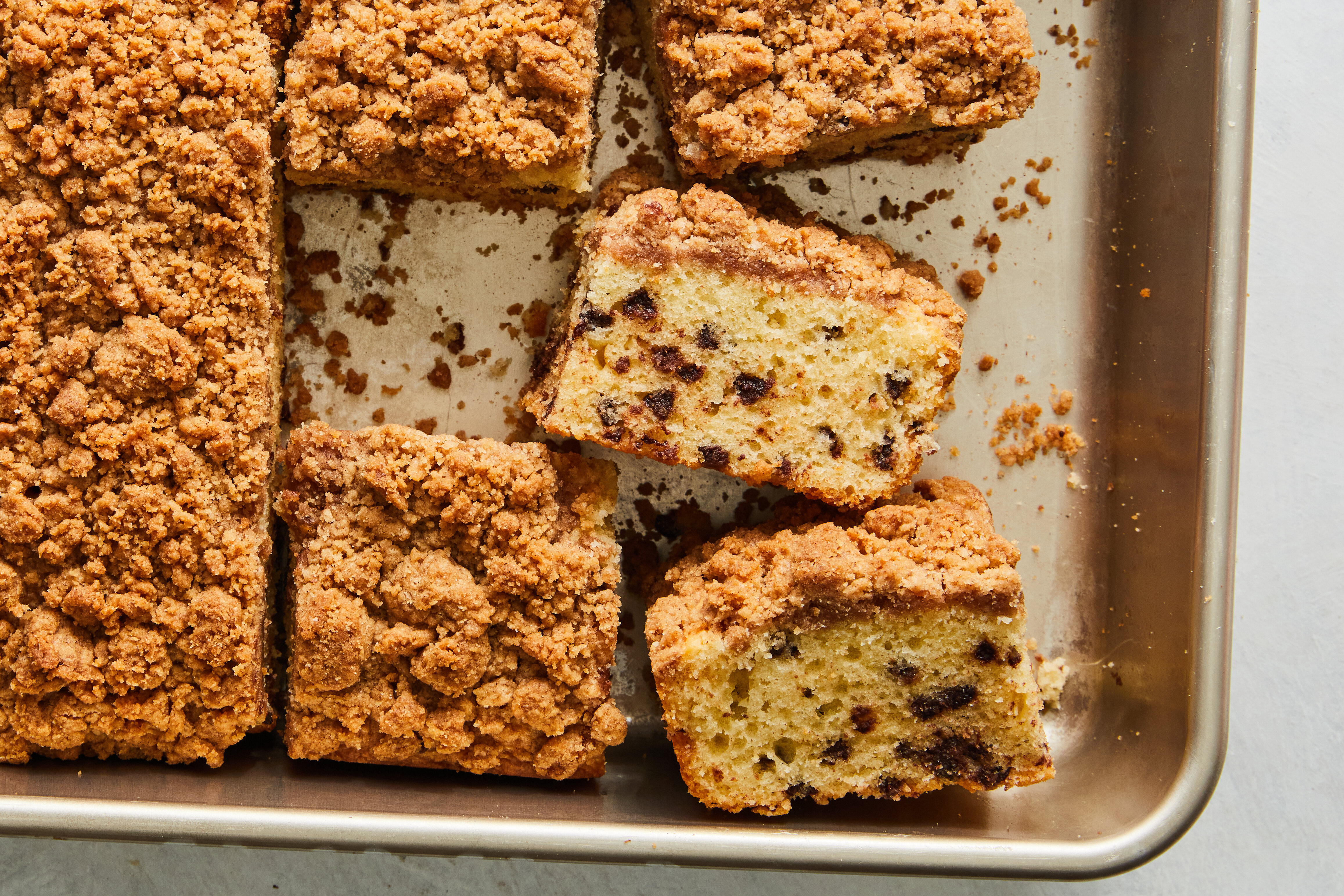 Several slices of coffee cake stacked neatly on a plate, ready to store or serve