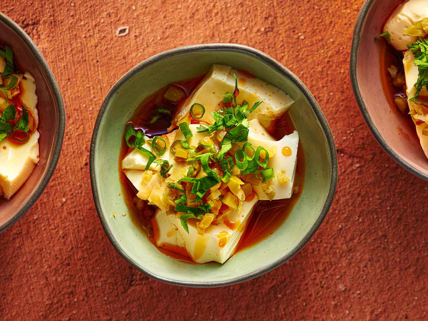 Silken tofu, soy sauce, rice vinegar, sesame oil, garlic, scallions, and mushrooms arranged and ready to cook