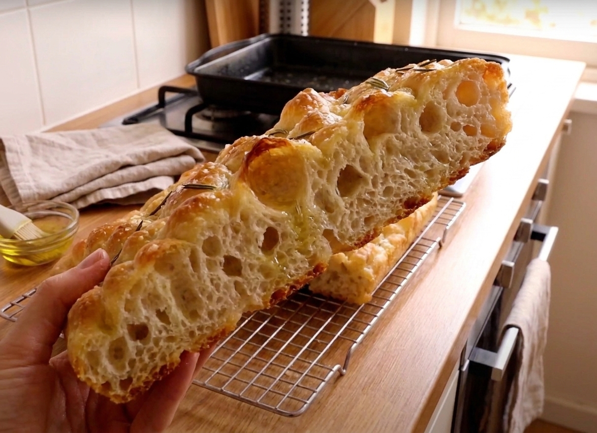 Sliced rosemary focaccia showing airy crumb and crisp edges