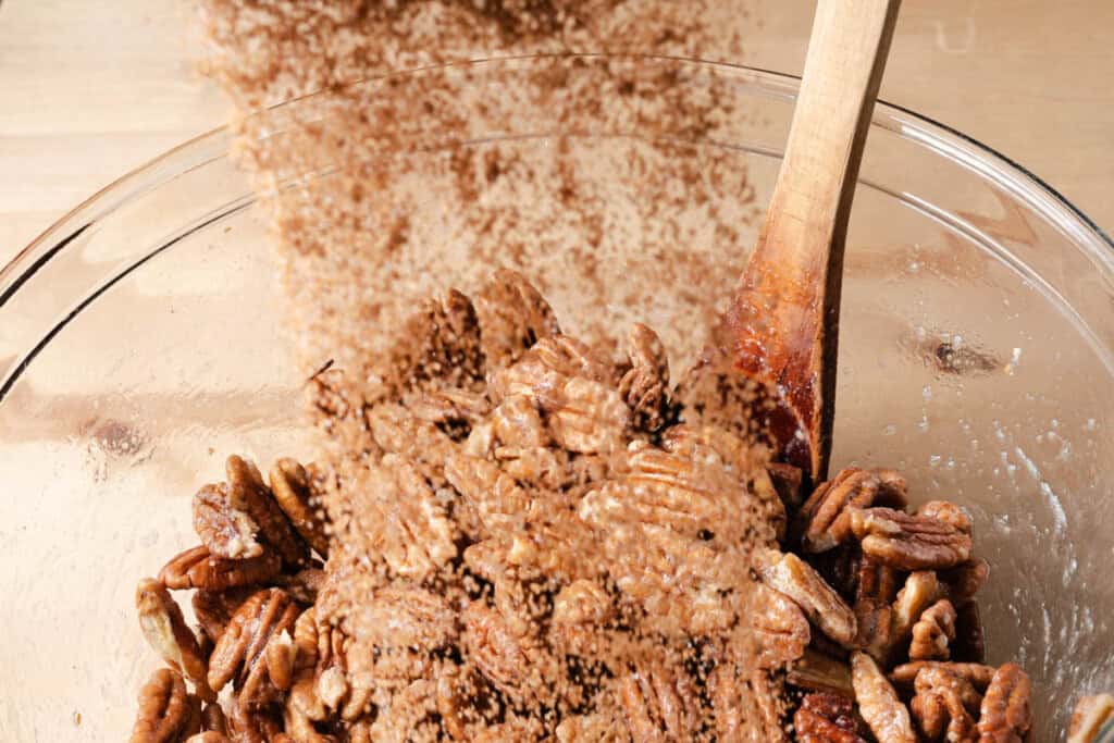 Small bowls of brown sugar, cinnamon, cayenne, and salt arranged on a kitchen counter ready for baking
