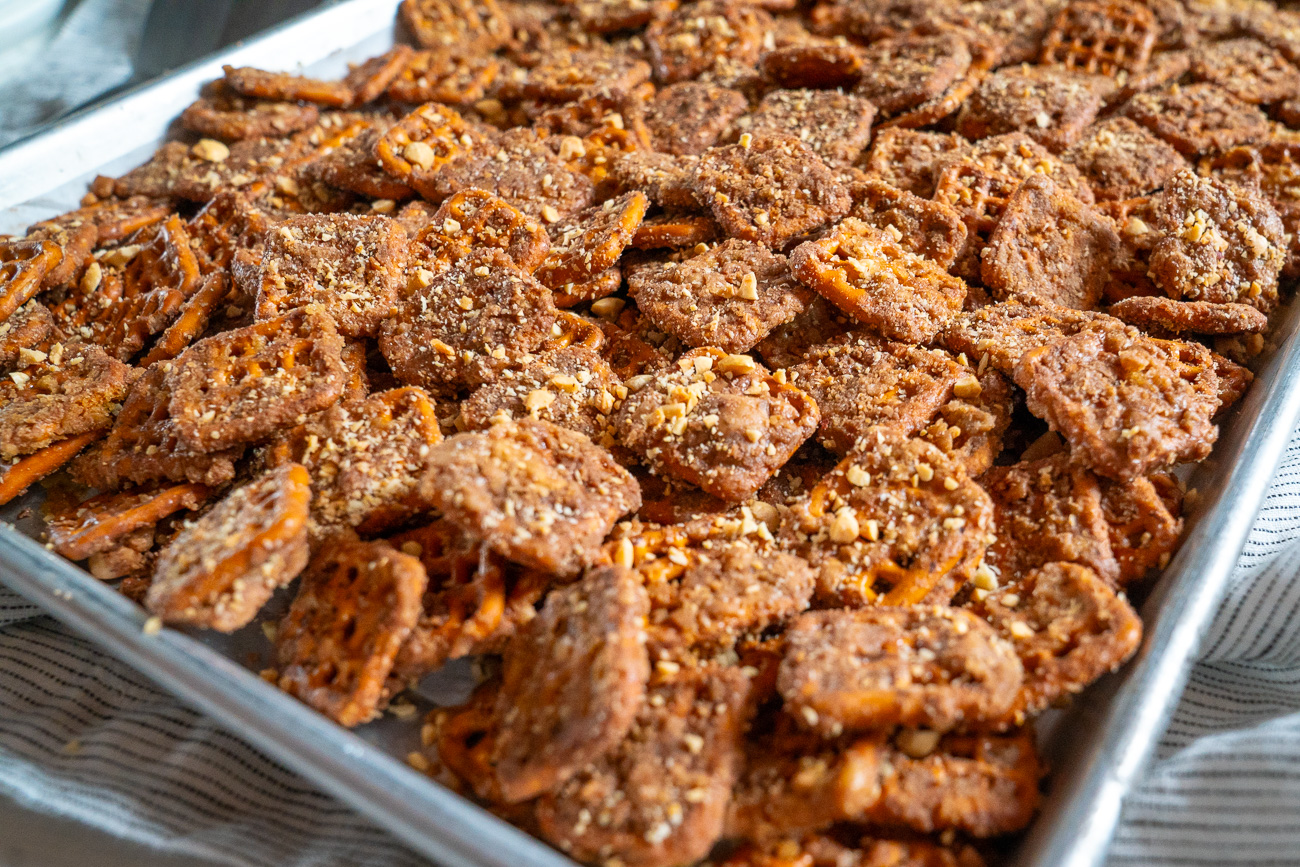 Small bowls of chopped almonds, crushed pretzels, dried cherries, and flaky salt ready to top cocoa bark
