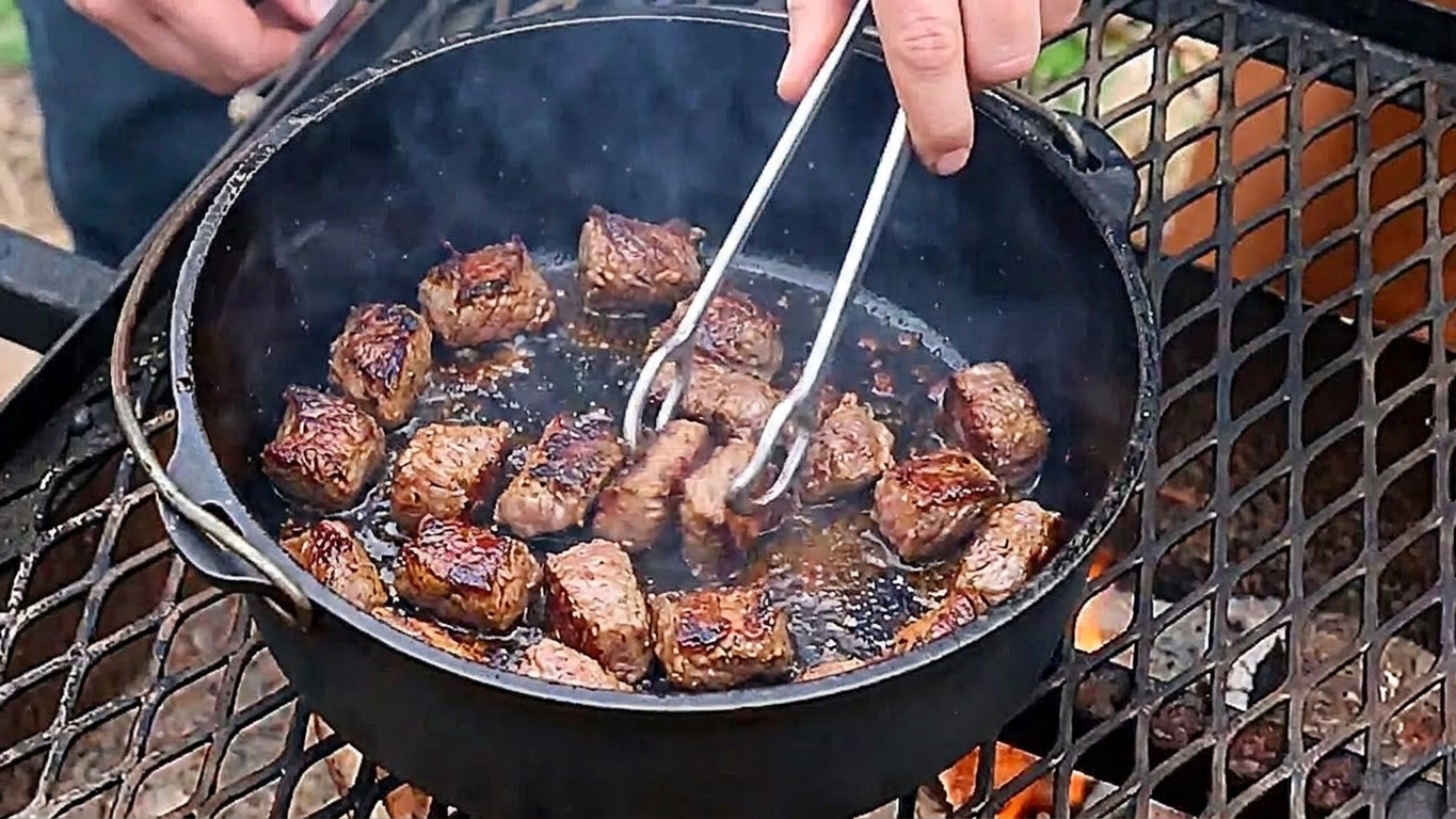 Small pieces of beef searing in a pot until browned with caramelized edges