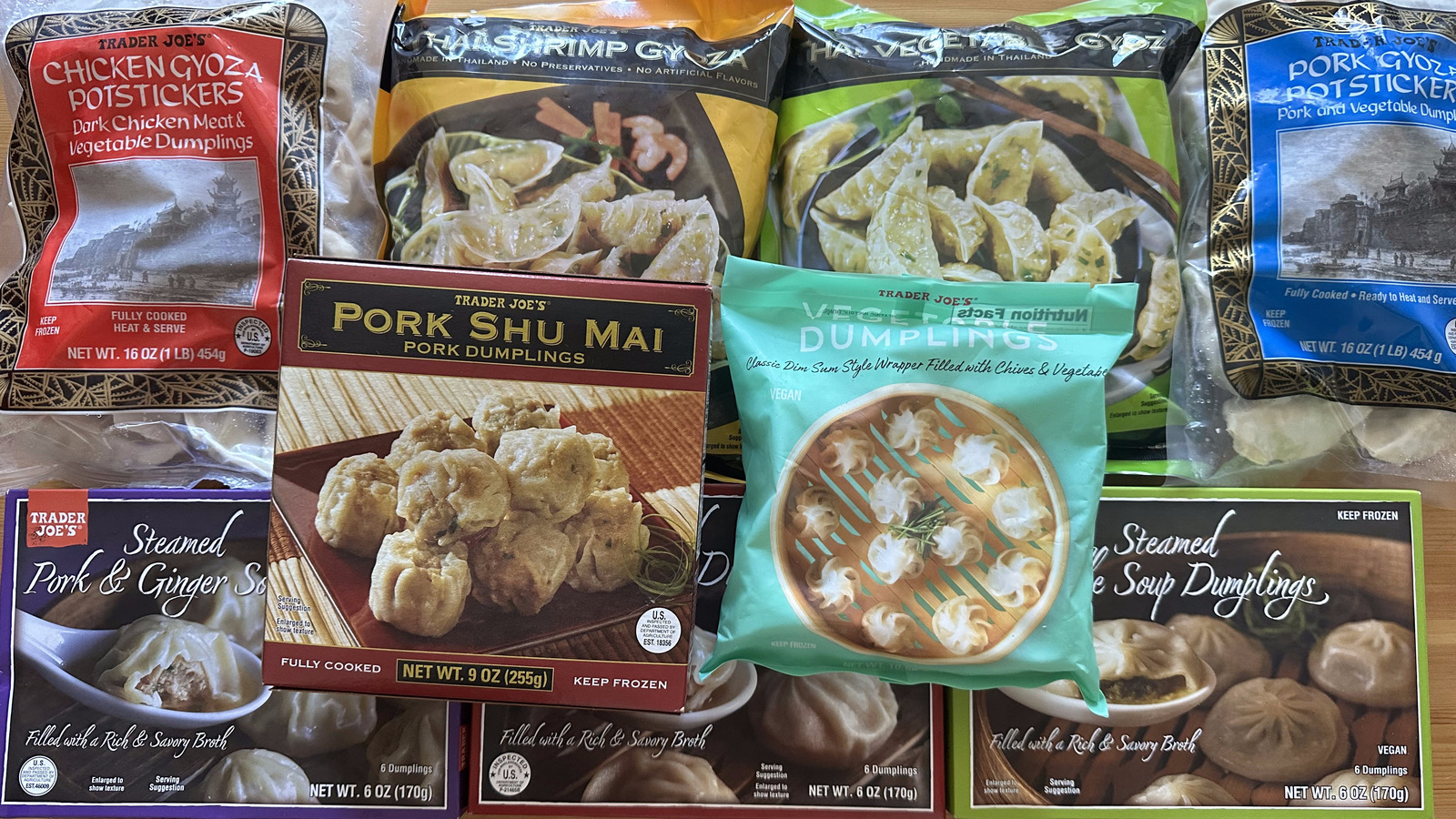Trader Joe’s frozen gyoza, a bag of frozen stir-fry vegetables, fresh garlic, fresh ginger, soy sauce, and a lime arranged on a bright kitchen counter